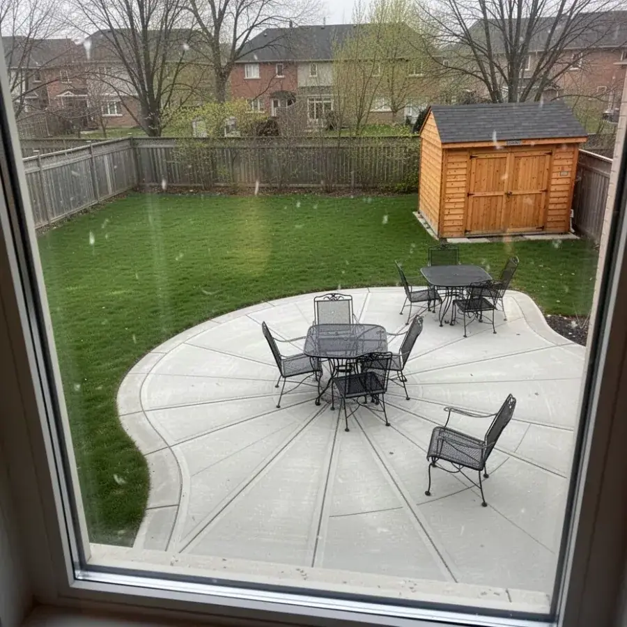 Curved concrete patio with planned joints in Cambridge yard